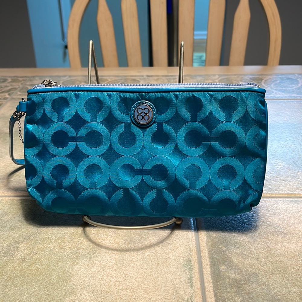 Coach wristlet with zipper closure.